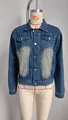 Close-up detail of women's casual washed denim jacket featuring classic chest pockets - Real Photo
