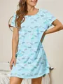 A detailed view of a light blue butterfly print nightgown on a model in a bedroom. - S / Dresses / Blue Butterfly