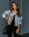 Detail of distressed denim jacket featuring leopard print panel and metal buttons. - S / Tops / Leopard Print