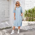 Blonde model posing in a light blue washed denim short sleeve midi shirt dress outdoors - S / Dresses / Light Blue