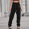 Close-up detail of women's black washed denim cargo pants featuring multiple utility pockets - S / Bottoms / Black