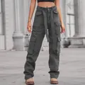 Close-up detail of high-waisted washed denim cargo pants with multiple utility pockets - S / Bottoms / Brown
