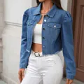 View of the fit and puff sleeve details on this blue cropped denim jacket over white - S / Tops / Blue