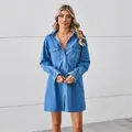 Loose light wash denim shirt dress with long sleeves and chest pockets on white background - S / Dresses / Blue