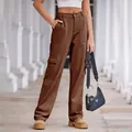 Stylish women's brown high-waist cargo pants with side pockets shown in outdoor setting - Brown