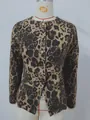 Close-up of the leopard print pattern and gold buttons on the slim-fit denim jacket - S / Tops / Leopard Print