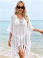 Elegant white hollow-out knit beach cover-up featuring a loose fit and stylish tassel hem details - Tops / White
