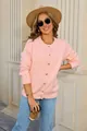 Detailed shot of a soft pink button-up knit cardigan worn by a model in outdoor setting - S / Tops / Pink