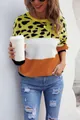Woman in color-block leopard print sweater and distressed jeans holding a coffee cup - S / Tops / Rust Red