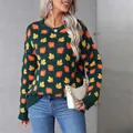Detailed view of dark green knit sweater featuring vibrant orange and yellow maple leaf patterns. - S / Dark Green