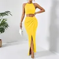 Elegant yellow pleated two-piece set with halter crop top and high slit maxi skirt - S / Top And Bottom / Yellow