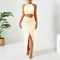 Elegant two-piece resort set featuring a halter crop top and pleated slit maxi skirt - S / Top And Bottom / Apricot
