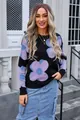 Close-up of women's black round neck sweater with large purple floral pattern print - S / Tops / Black