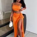 Sexy vibrant orange two-piece set with a one-shoulder top and high slit maxi skirt - Orange