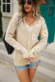 Macro view of a stylish beige knit cardigan featuring large white daisy prints and buttons - S / Tops / Apricot