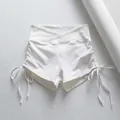 Primer plano de pantalones cortos de yoga blancos con lados fruncidos y cordones. - S / Bottoms / Blanco