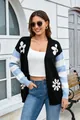 Close-up detail of women's relaxed knit cardigan with floral print and striped sleeves - S / Tops / Black