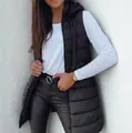 Detail view of a long black hooded quilted vest with zipper closure over white top - S / Tops / Black