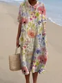 Detailopname van het kleurrijke bloemenpatroon op een loszittende zomerse maxi-jurk aan zee. - XS / Aquarel Bloemenprint Jurk (Stijl 4)