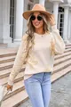 Outdoor street style view of a cream floral knit sweater on a model with a hat. - S / Tops / Apricot and Yellow