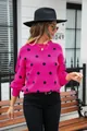 Fashionable pink knit sweater with black polka dots worn by a model - Rose Red