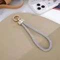 Elegant sparkling silver rhinestone wrist strap featuring a golden bow keychain for phone or bag. - Charm / Bow 10-Row Rhinestone Chain Charm (K5761) / White