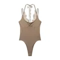 Detailed view of coffee rib-knit bodysuit with delicate lace patchwork and halter neck - Camel