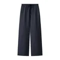 Detail view of dark navy wide-leg trousers featuring elastic waist and drawstring design - S / Bottoms / Dark Blue
