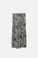 Detail view showing the elegant zebra print pattern and silky satin texture of the midi skirt. - Zebra Print
