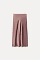 Detailed view of the smooth satin texture and elegant drape of a dusty rose midi skirt - Dusky Pink
