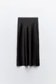 Detailed view of elegant black silk satin midi skirt with smooth drape and sheen - XS / Bottoms / Black