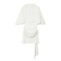Detailed view of white backless mini dress featuring sequin embellishment and flutter sleeves. - XS / Dresses / White