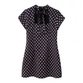 Close-up of polka dot mini dress featuring a cutout neckline and bow tie detail - Purple