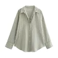 Detailed view of a striped satin-finish blouse with elegant green vertical patterns. - Green Stripe