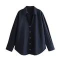 Close-up front view of a navy blue long-sleeve shirt with satin texture and button details - Navy Blue