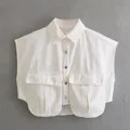 Close-up of white cropped denim vest with utility pockets and metal buttons - S / Tops / White