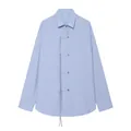 Detailed view of light blue linen shirt featuring unique oriental tie-up closures - XS / Tops / Light Blue