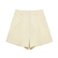 Detail view of high-waisted linen blend pleated shorts in cream for summer wear - XS / Bottoms / Beige Apricot