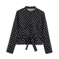 Detailed view of women's black and white polka dot shirt jacket featuring tie waist and pockets - XS / Tops / Black Polka Dot