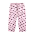 Detailed view of pink cropped casual pants featuring a classic black polka dot pattern - XS / Bottoms / Pink Polka Dot