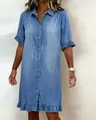 Detailed view of light blue denim shirt dress featuring ruffle hem and button-up front. - S / Dresses / Blue