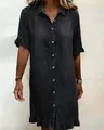 Detail of dark grey denim shirt dress featuring ruffle sleeves and button-front - S / Dresses / Black