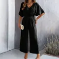 Elegant black short sleeve V-neck jumpsuit with wide legs for women in spring and summer. - S / Black