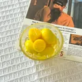 Detail view of creative yellow lemon food miniature magnets in a glass bowl with ice. - Ice Cold Lemon Glass Bowl
