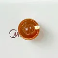 Macro top-down view of miniature mango sago pomelo dessert resin bowl for DIY crafts - Amber