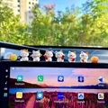 Macro view of six cute mini Maneki-neko lucky cat figurines on a car center console. - 6 Lucky Cats Plus 2 Peeling Tangerines Set