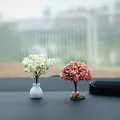 Detailed view of miniature artificial cherry blossom trees on a car dashboard interior - 2 Pieces/Set / Pink & White Mixed