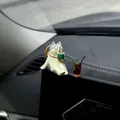Macro view of healing cat figurine and mini iced coffee ornament on car dashboard - Tea Drinking Cat