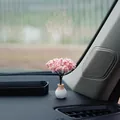 Elegant miniature pink cherry blossom simulation tree ornament placed on black car dashboard - Cherry Blossom Tree
