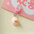 Close-up detail view of a cute pink strawberry miniature food keychain accessory - Round Strawberry Cake